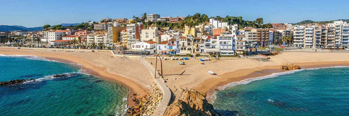 Coast of spain, the beach dividing the ocean - visually - into two.