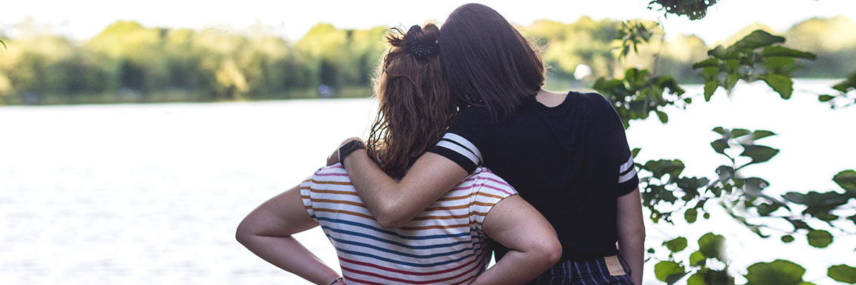 Two au pairing friends look at a lake