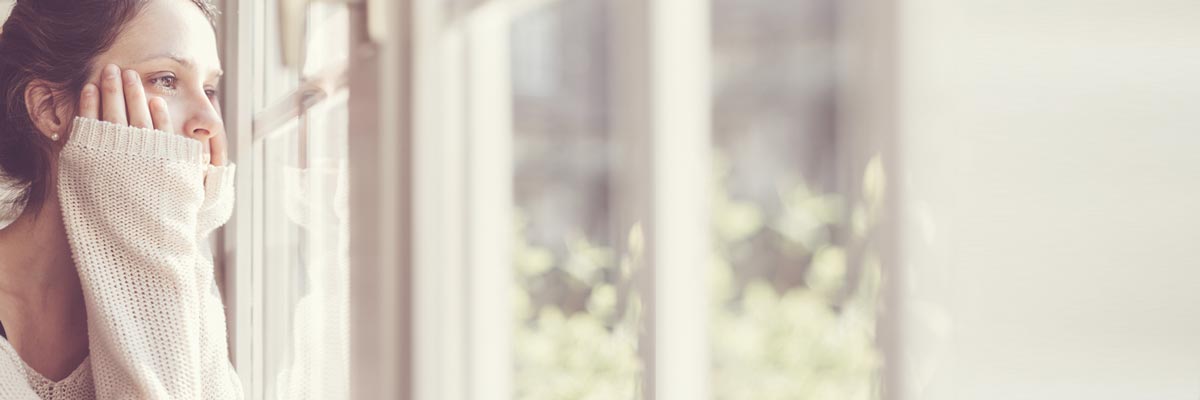 young woman looking out of a window