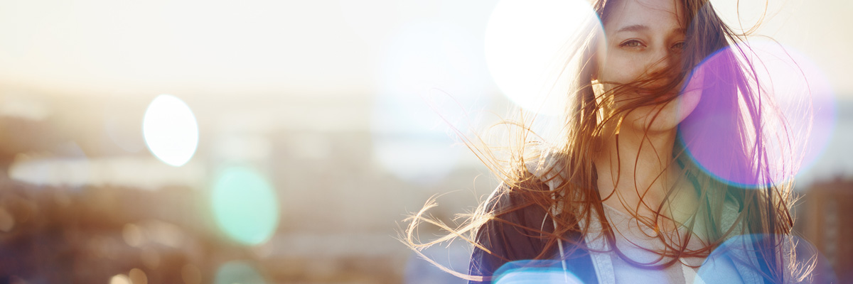 Female au pair with hair blowing in the wind