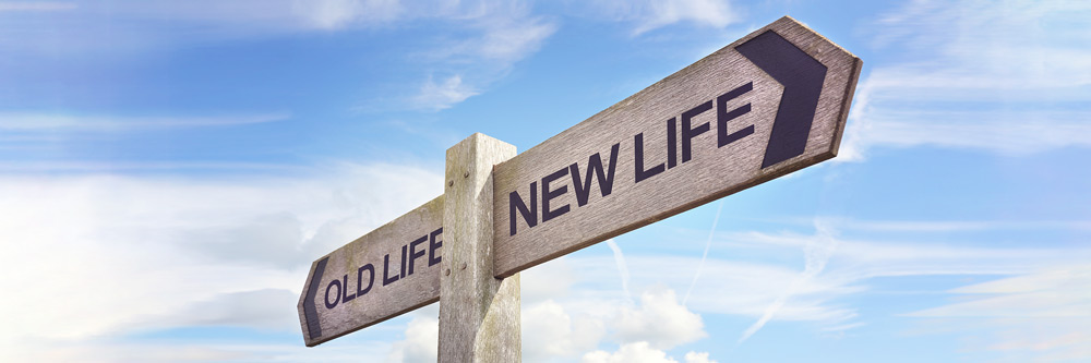 A signpost with two directions - old life and new life
