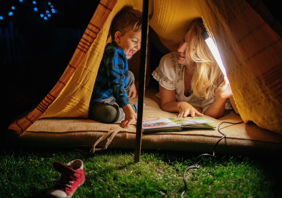 Au pair with child in a tent