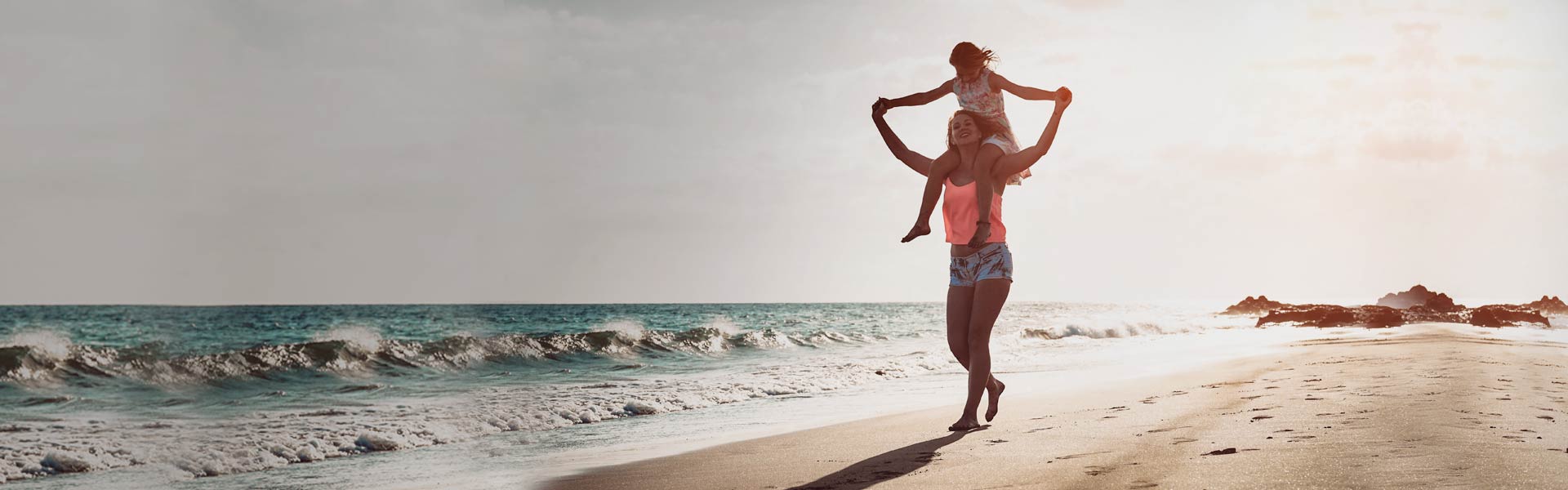 Au pair and child at the beach