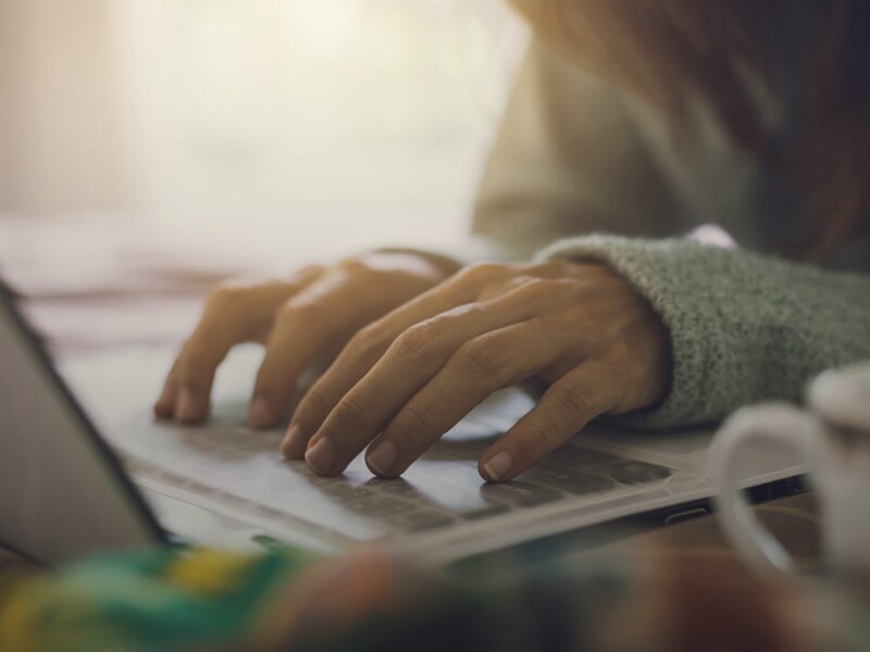 A person typing in a keyboard