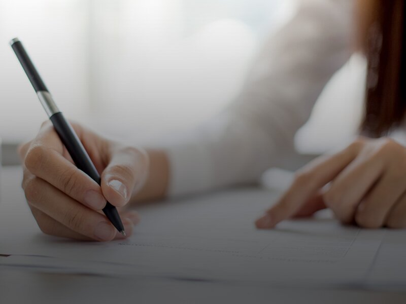 Woman signing a contract