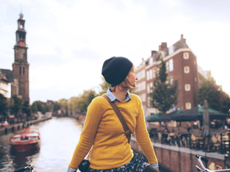 A young woman on a bridge in Amsterdam