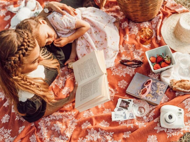 Au-pair reading a book for a child