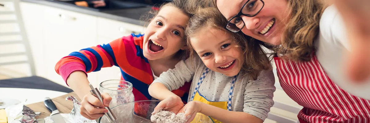 Children help their mother with cooking