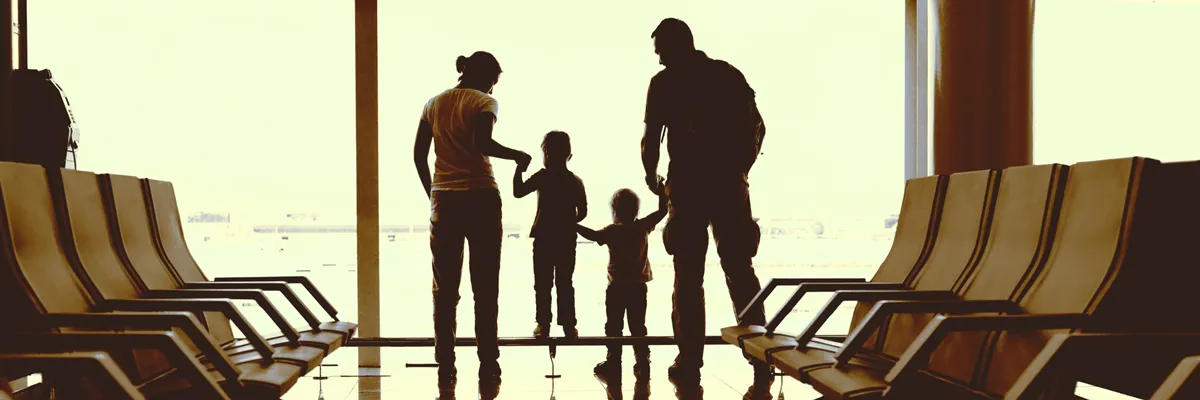 A family waits at the airport for their new au pair