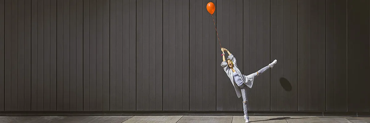 Woman holding a red ballon