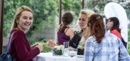 Trois filles parlent à l'extérieur du bâtiment