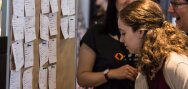 An au pair places her profile card at the attendant's board