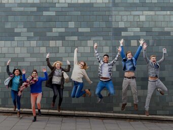 A group of young people jumping