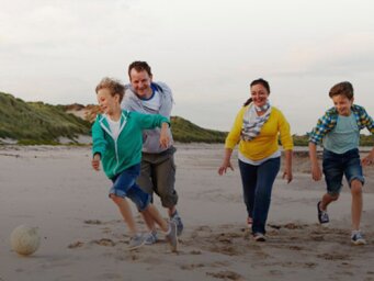 Family playing on the beach