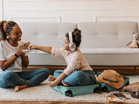 A young girl and a kid playing together in a living room