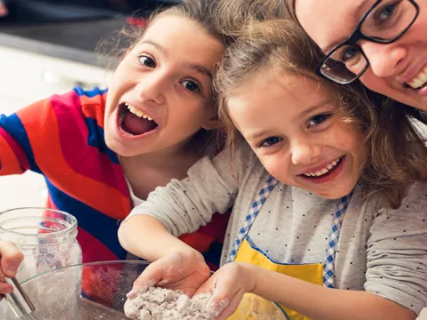 Children help their mother with cooking