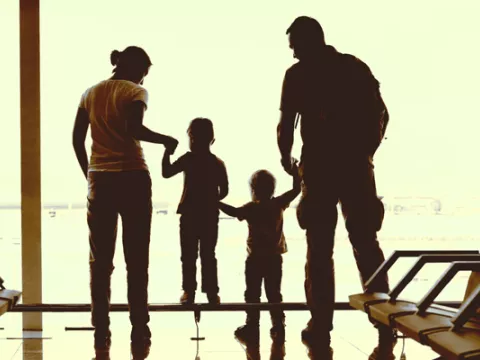 A family waits at the airport for their new au pair