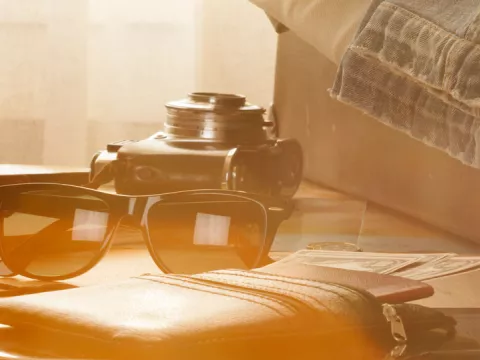 Suitcase, sunglasses, passport and notebook