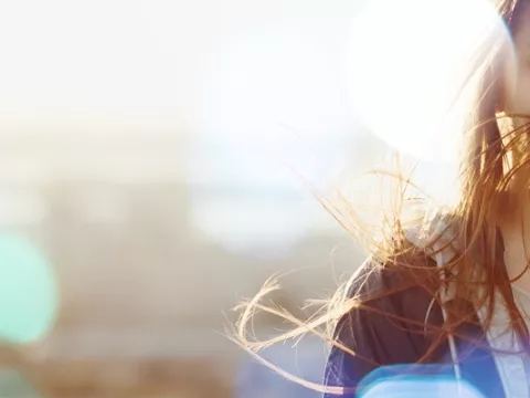 Female au pair with hair blowing in the wind