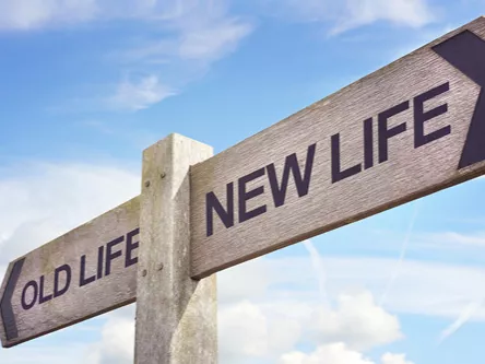 A signpost with two directions - old life and new life