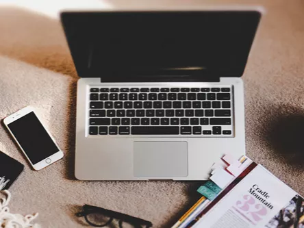 Laptop, camera, cellphone and a cup of tea