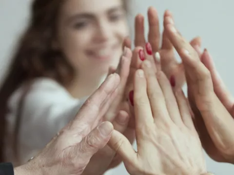 A group of people put their hands together to show their bond