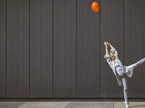 Woman holding a red ballon