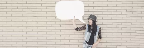 Young Woman holding a paper speech bubble