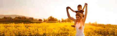 Girl with a child on her shoulders