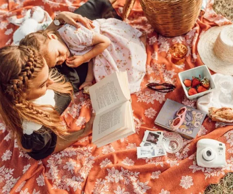 Au-pair reading a book for a child