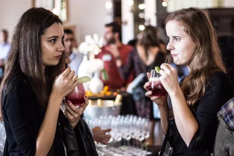 Two au pairs exchanging experiences with a drink