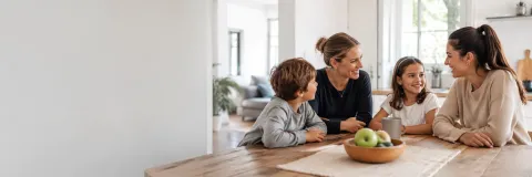 Family sitting at table with au pair