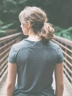 Young Woman walking over a bridge