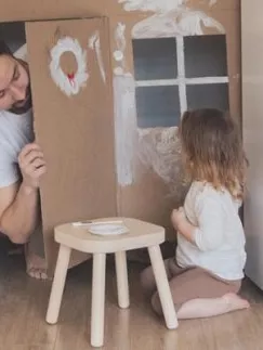 A young man playing with a child