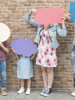 Family holds speech balloons in the air