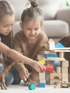 A nanny plays with children