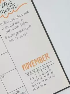 An open appointment diary with a cup of coffee