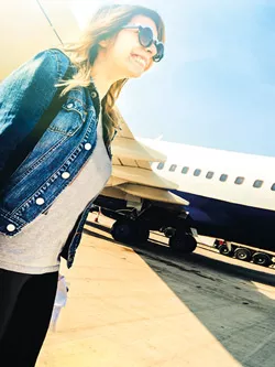Young woman with a suitcase at the airport