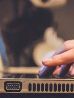 Hands typing on a laptop