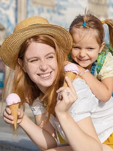 A Woman eating some icecreme with a child